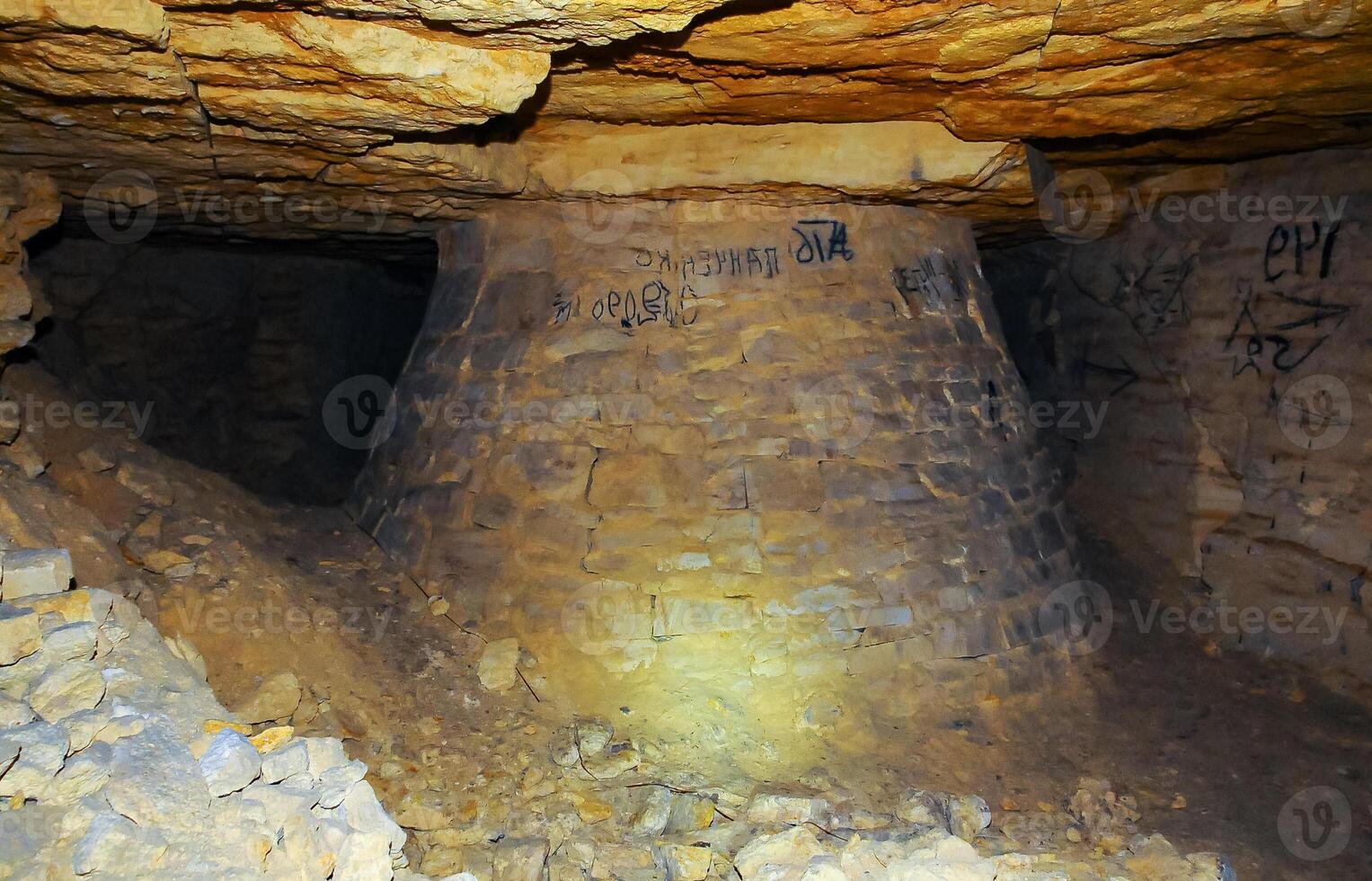 Fortifications in the form of round pear-shaped pillars made of saw shell rock in the Odessa catacombs photo