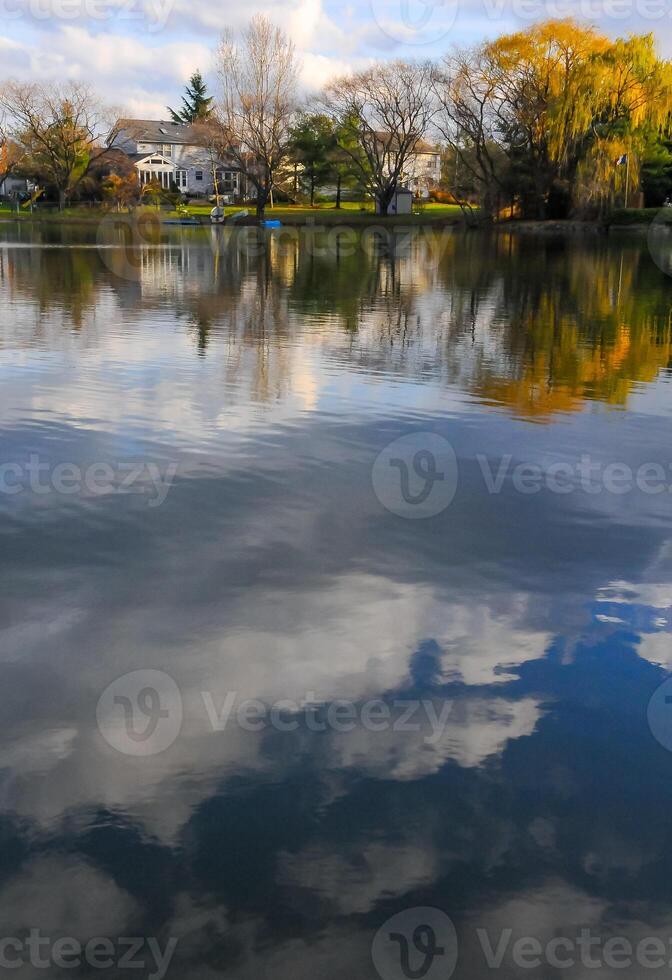 Natural Landscape, Reflection of clouds and lodges in the water of a quiet lake in New Jersey photo