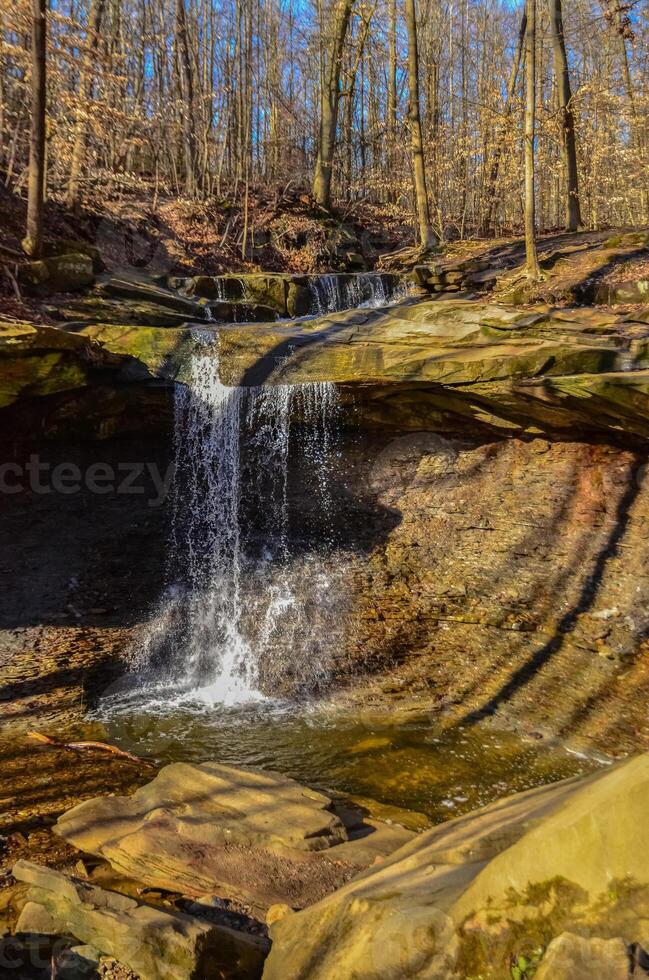 A small waterfall in the autumn in the forest in the parkon Brandywine Creek in Cuyahoga Valley National Park, Ohio. photo