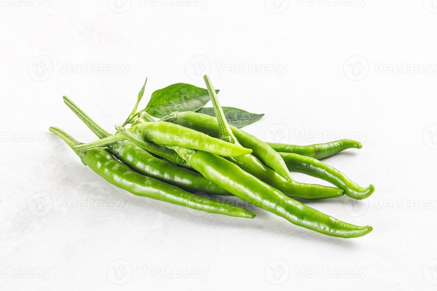 Spicy green chili pepper heap photo