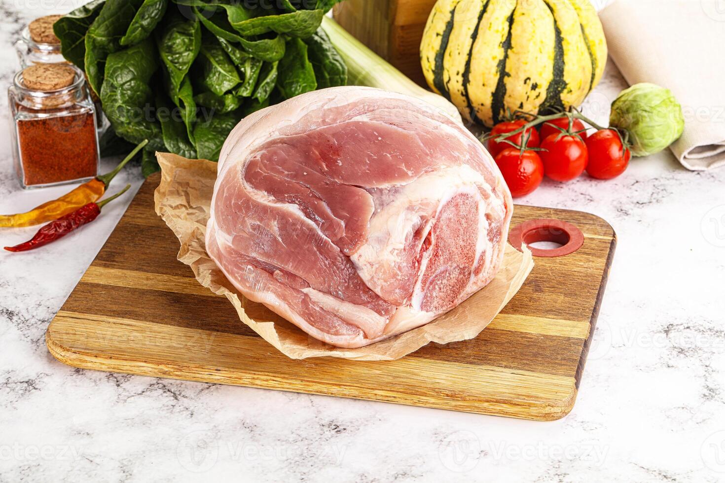Uncooked raw pork knuckle with spices photo