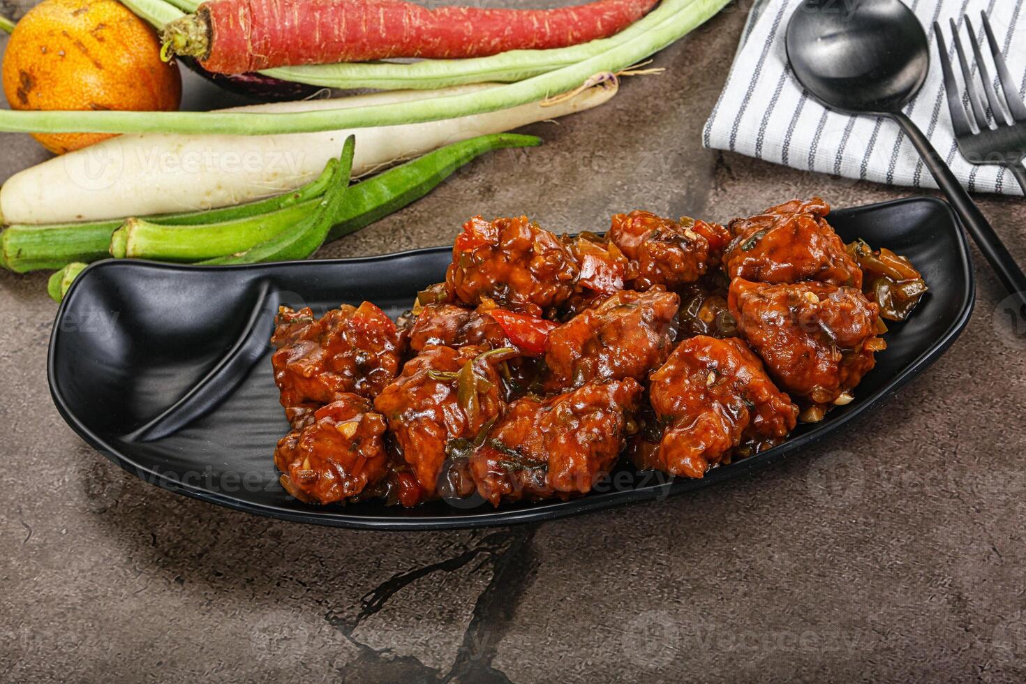 Manchurian chicken with sauce and spices photo