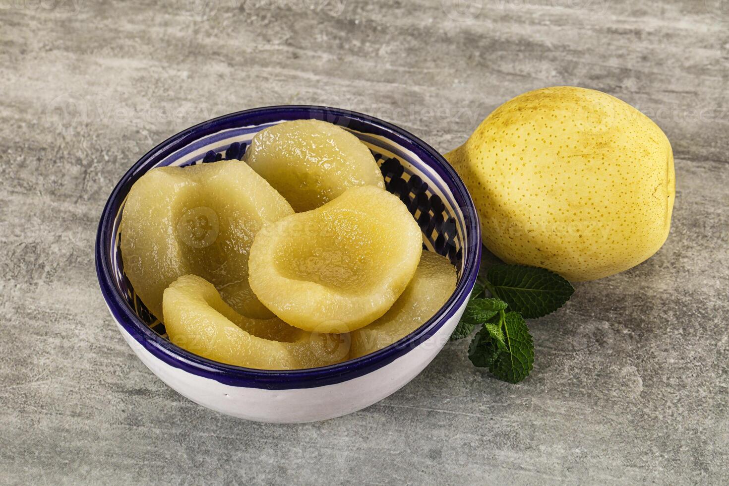 Canned yellow pear with syrup photo
