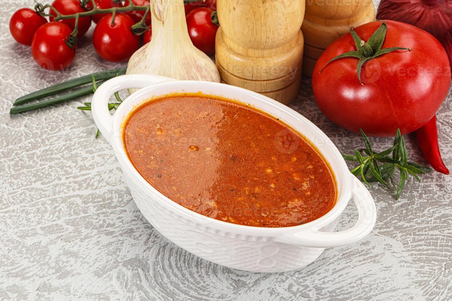Hot tomato soup with diced chicken photo