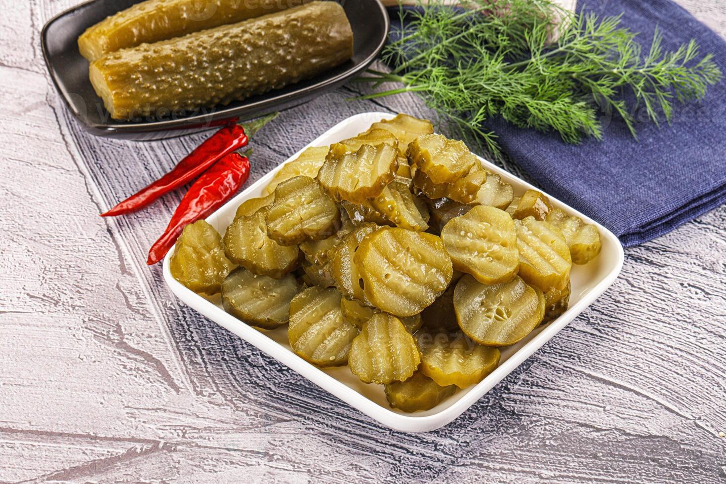 Sliced marinated cucumbers in the bowl photo