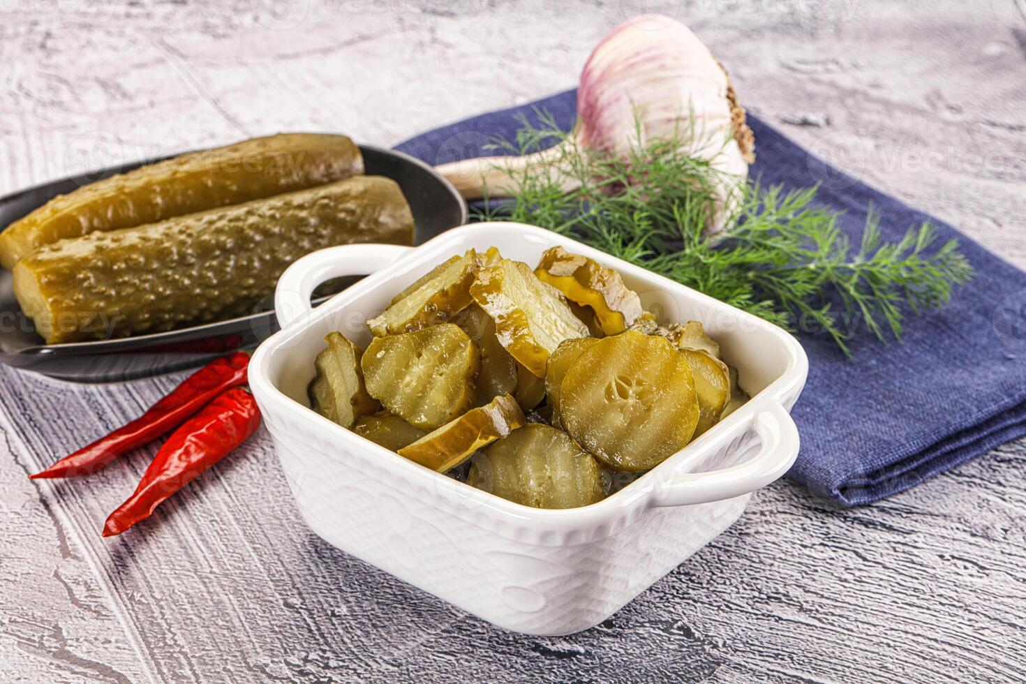 Sliced marinated cucumbers in the bowl photo