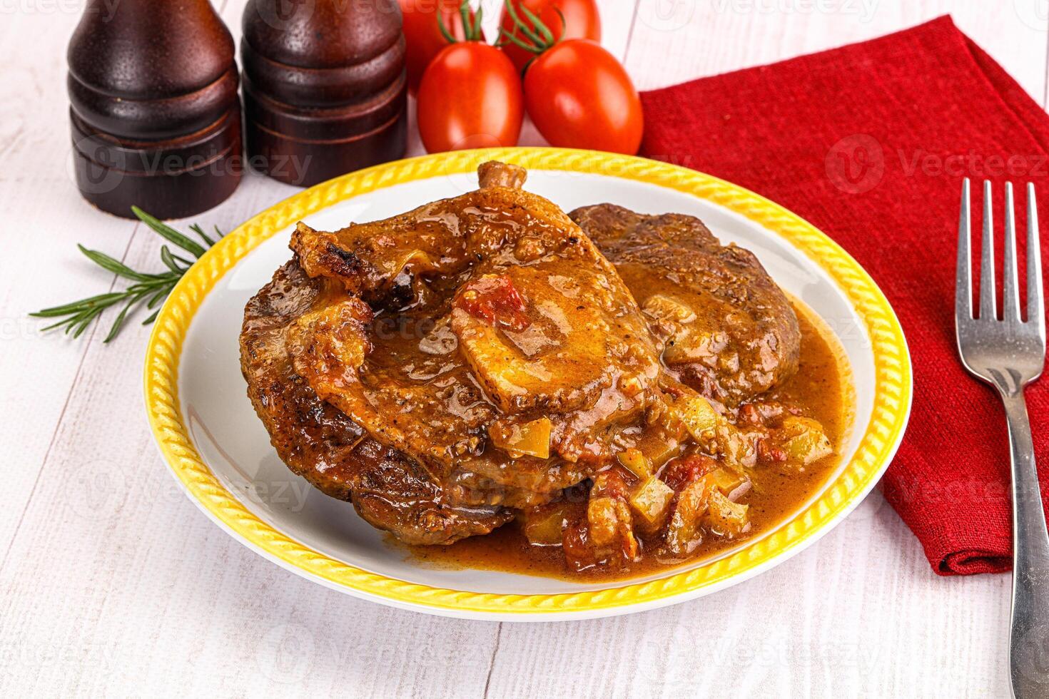 Italian cuisine - ossobuco with sauce photo