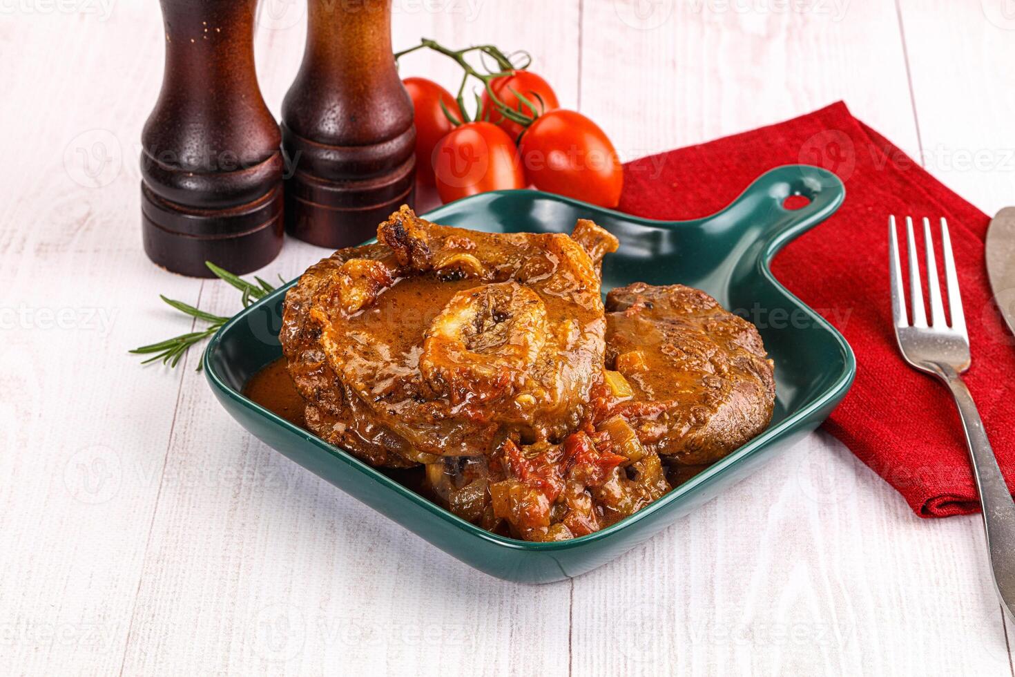 Italian cuisine - ossobuco with sauce photo