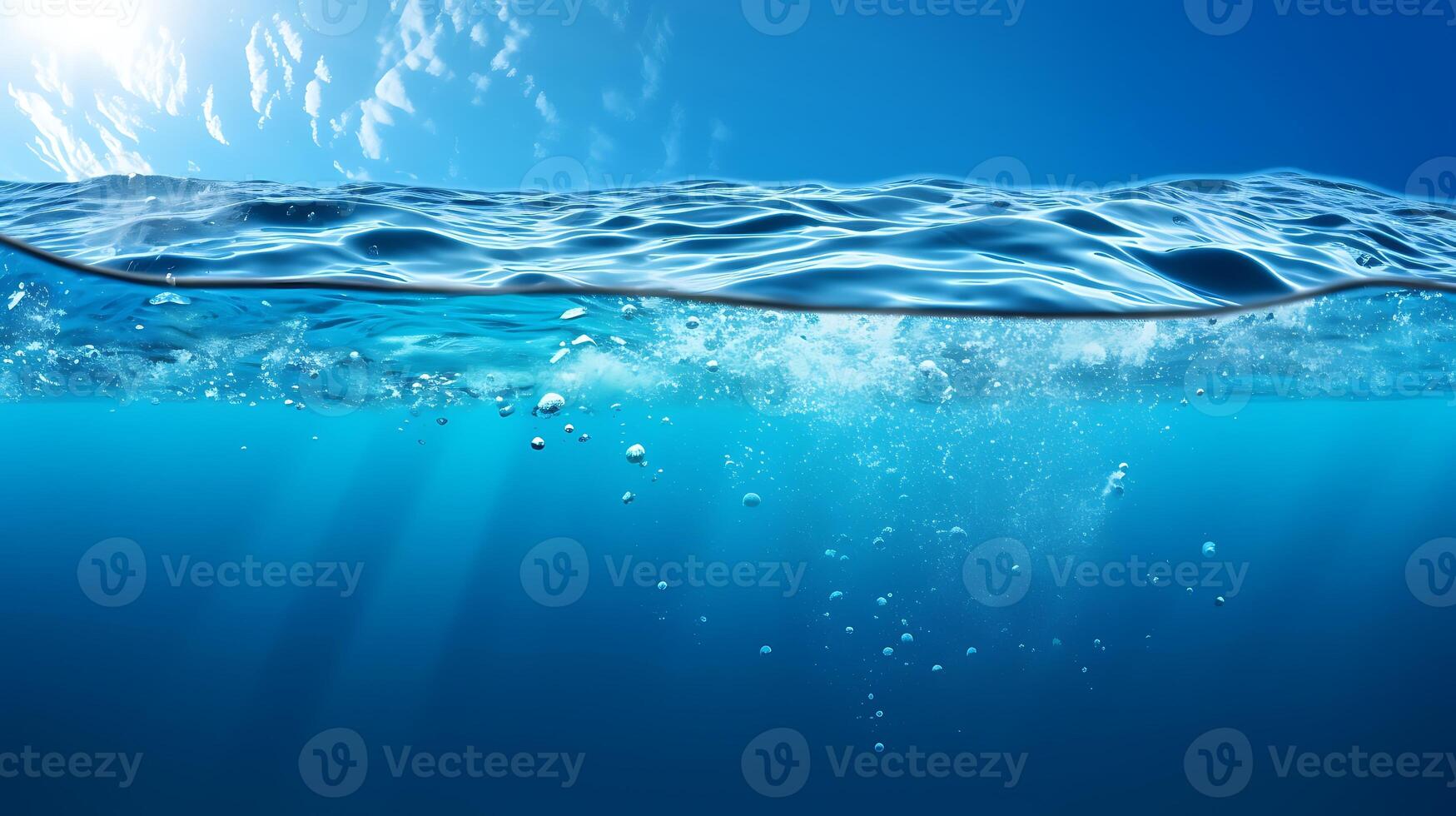 Waterline Split view horizon of sky and blue underwater ocean with sunrays photo