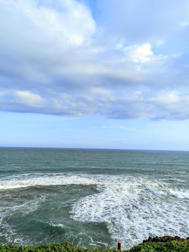 Vast ocean with cloudy sky during the day photo