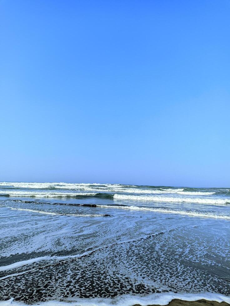 The calm waves crashing towards the beach photo