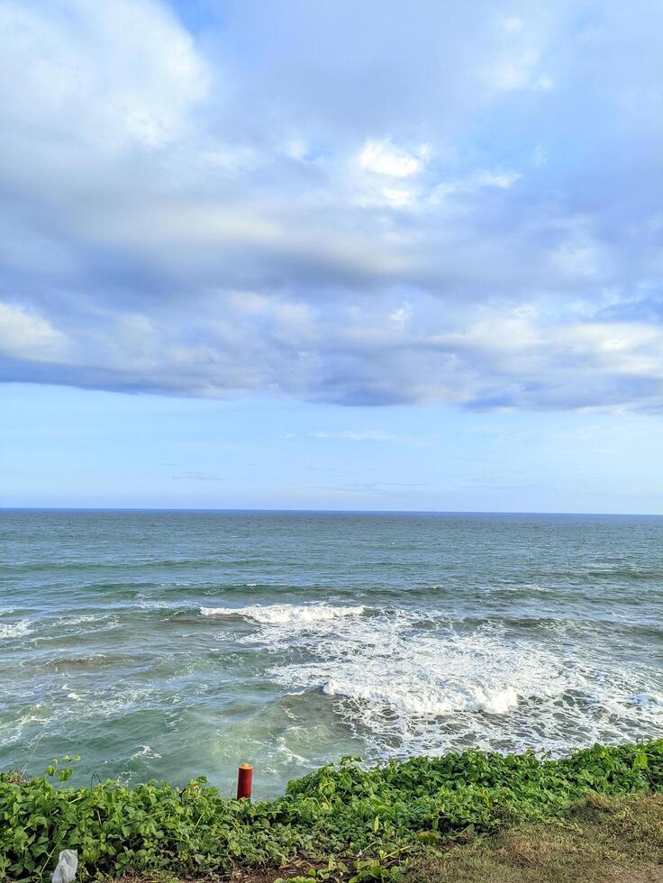 A calm atmosphere on the beach with fresh air and the sound of waves crashing against the rocks photo