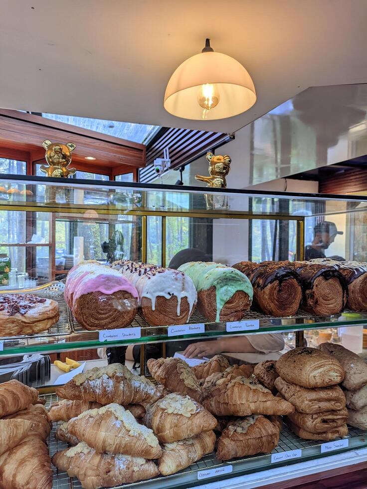 Various kinds of desserts such as croissants, cromboloni and breads with colorful toppings are sold at of the cafes photo