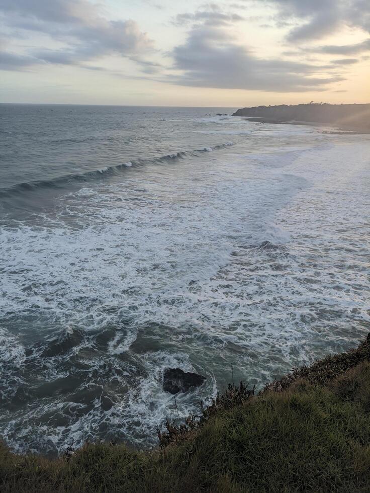 The waves get bigger as evening approaches because the sea water is high tide photo