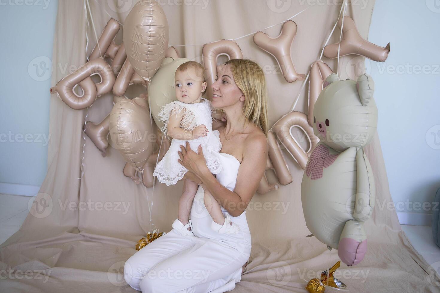 photo session on the first birthday of a baby girl with her mother, in pastel colors, minimalism