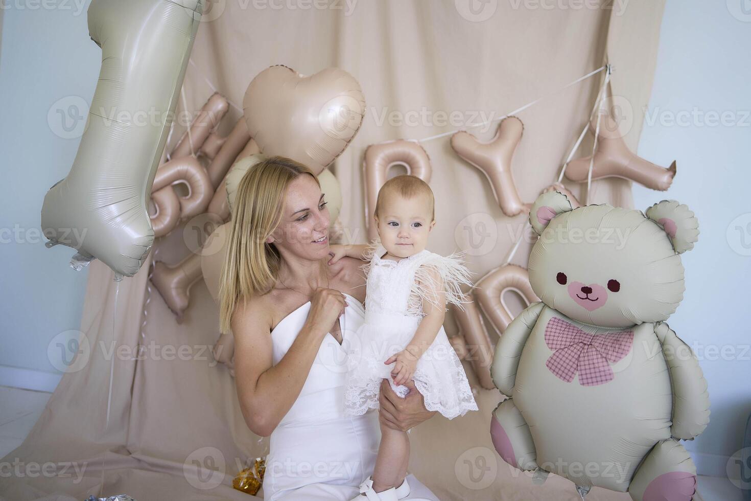 photo session on the first birthday of a baby girl with her mother, in pastel colors, minimalism