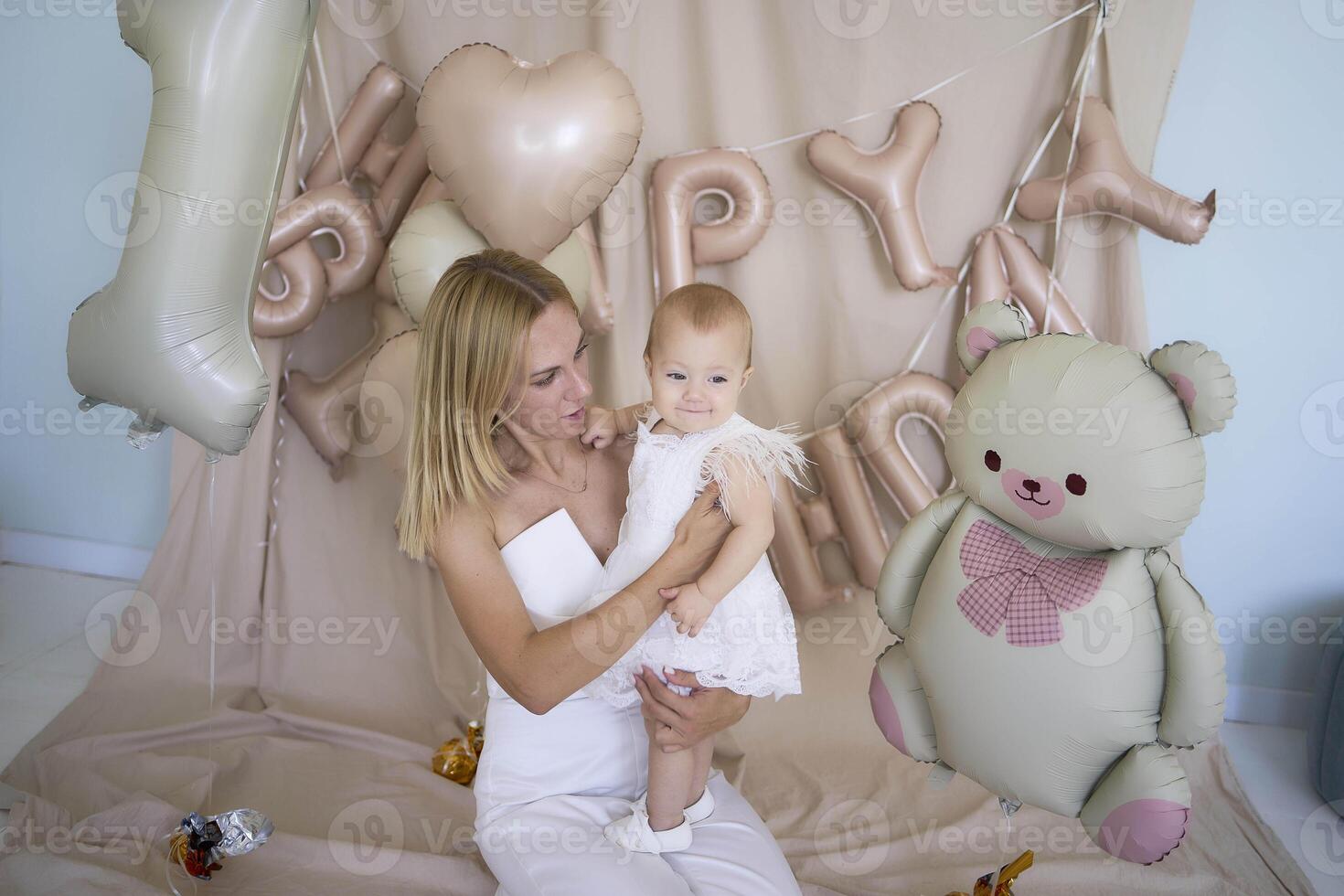 photo session on the first birthday of a baby girl with her mother, in pastel colors, minimalism