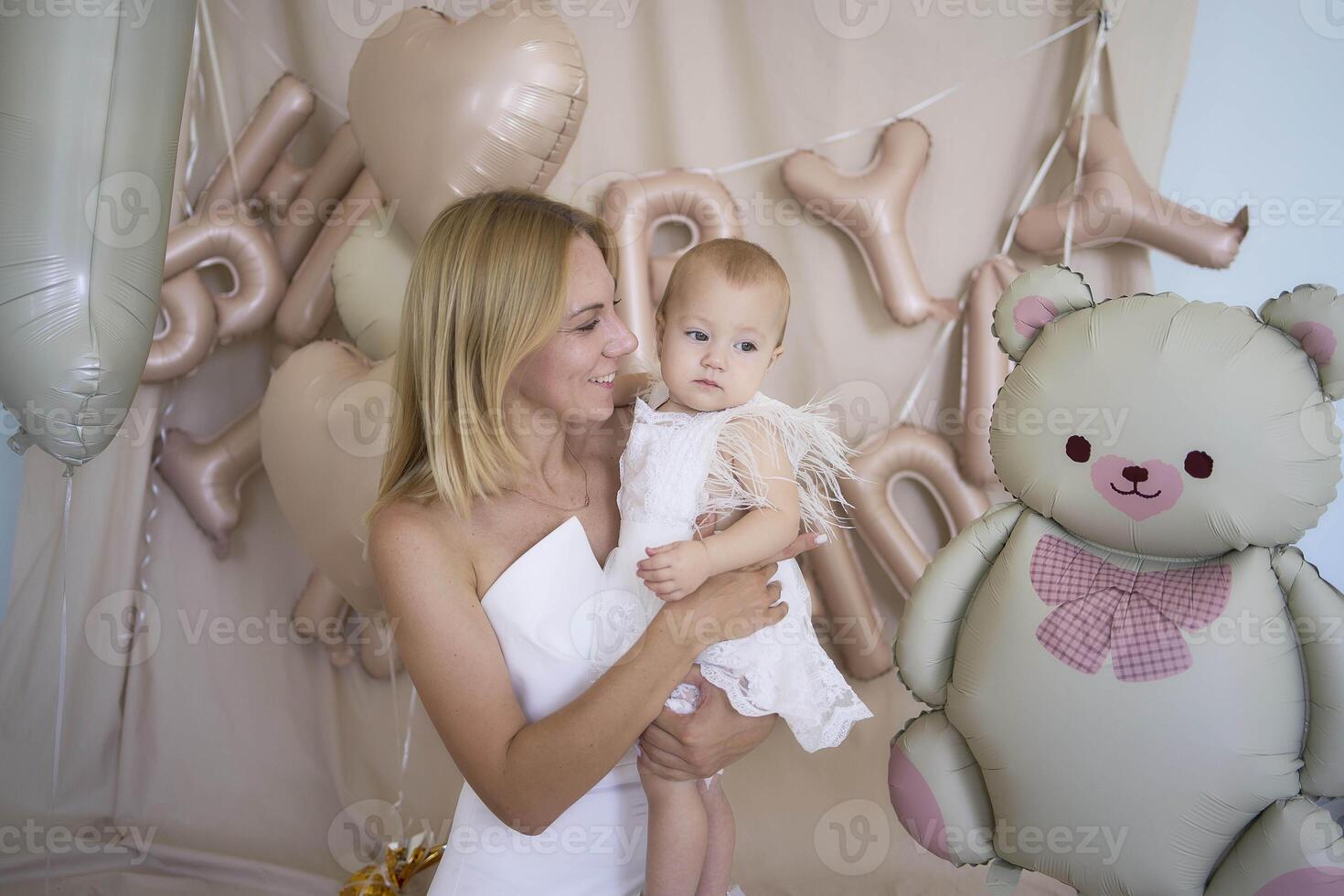 photo session on the first birthday of a baby girl with her mother, in pastel colors, minimalism