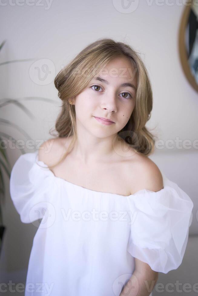 beautiful pre-teen girl in white clothes in a stylish minimalist interior photo
