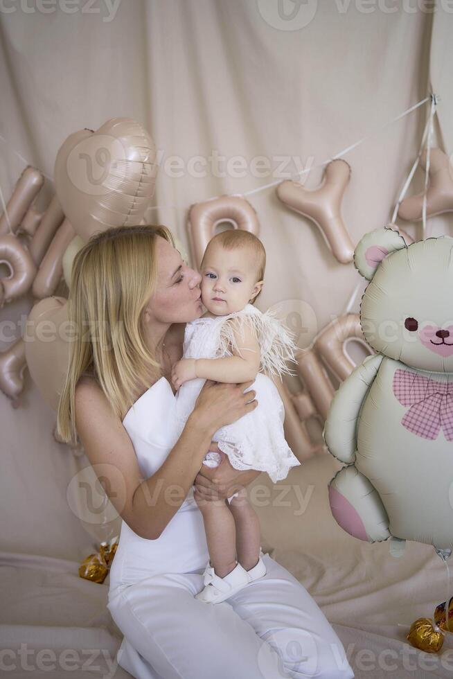 photo session on the first birthday of a baby girl with her mother, in pastel colors, minimalism