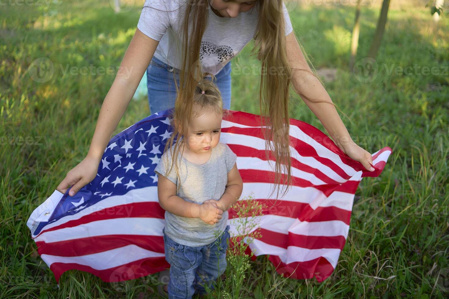 a toddler with american flag on independence day picnic photo