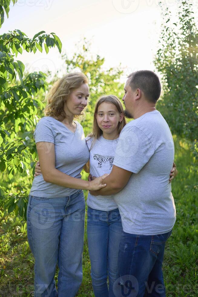 parents and their teenage daughter in the park photo