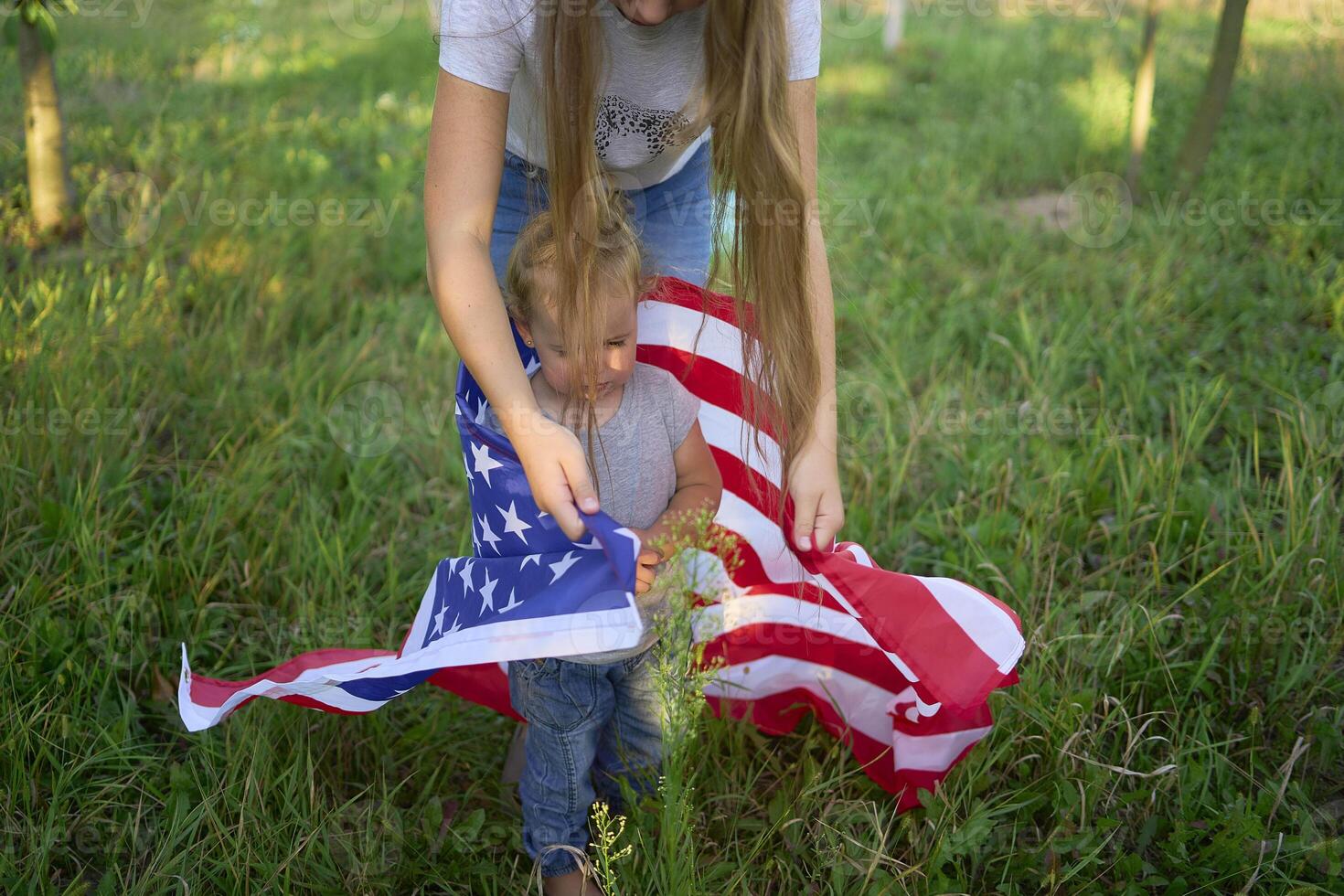 a toddler with american flag on independence day picnic photo
