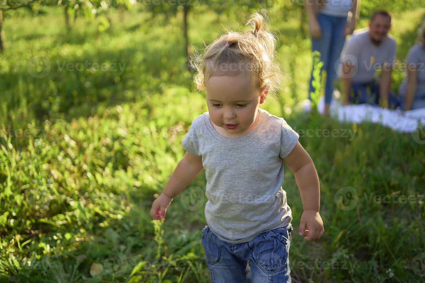 toddler screams and cries in front of family on picnic in garden photo