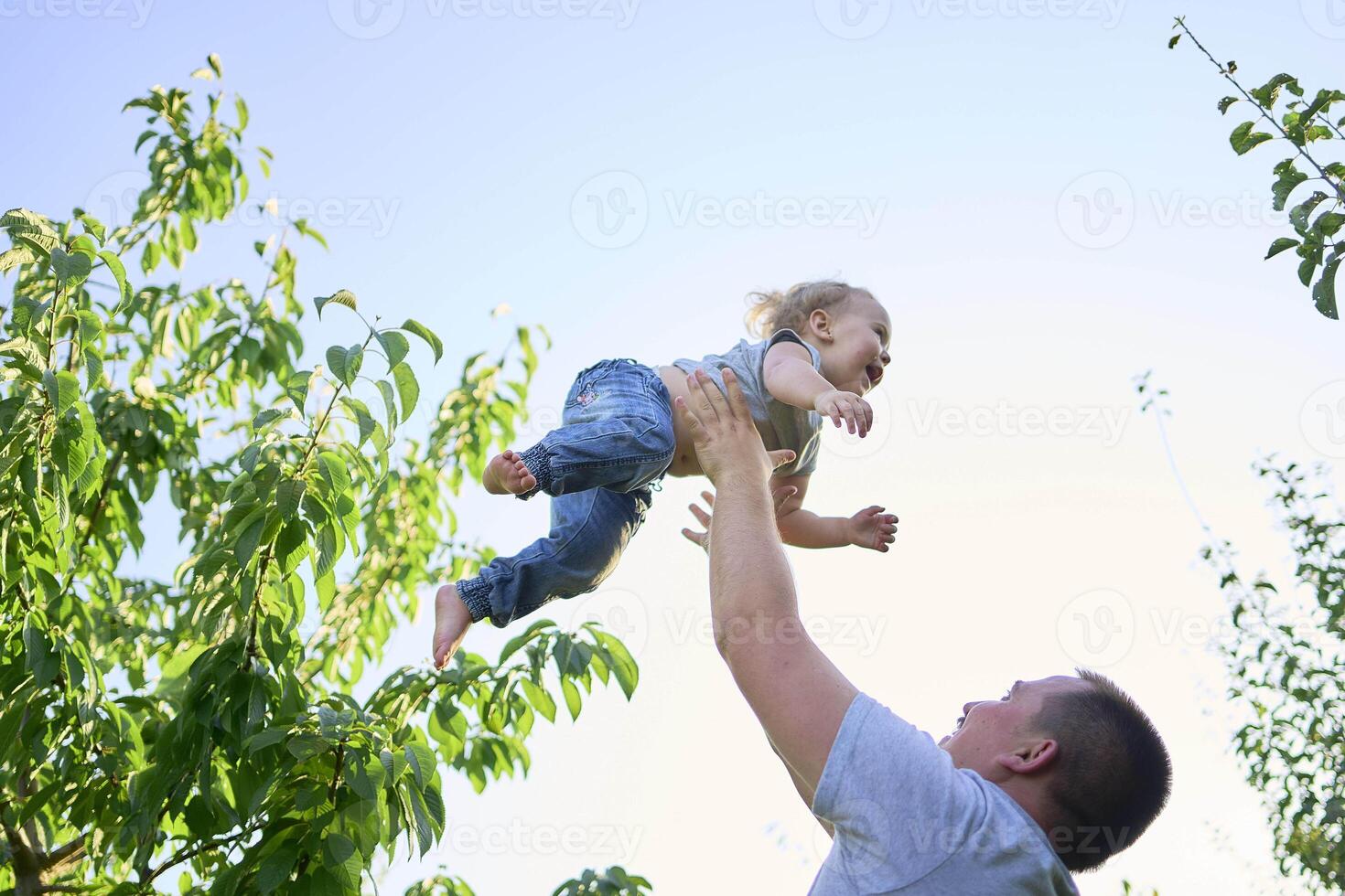 a father plays with a toddler on his shoulders photo