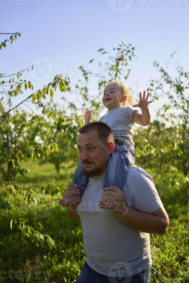 parents ride their children on their backs photo