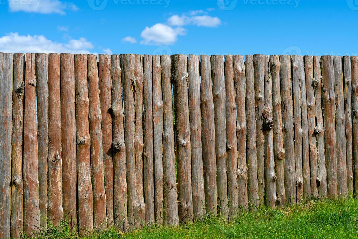 Log wooden fence. The texture of the old wooden fence. Wooden vintage background. photo