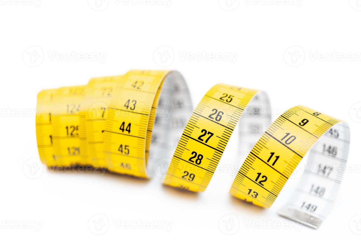 Yellow measuring tape on white background. Measurement of length and circumference. Lose weight and get fat. photo