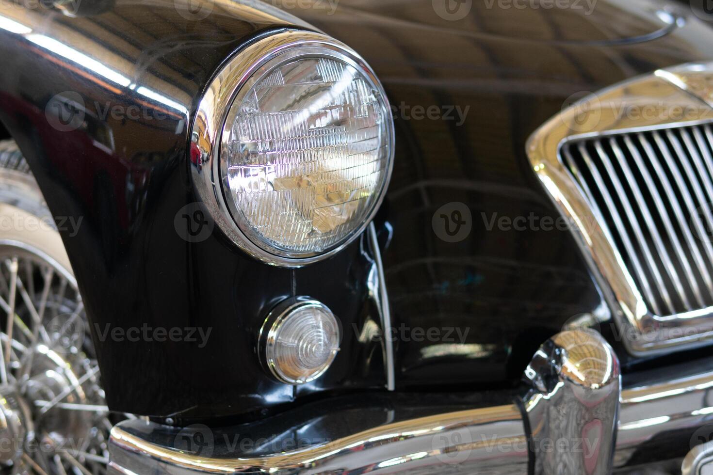 The headlight of an antique, rarity, vintage black car. photo