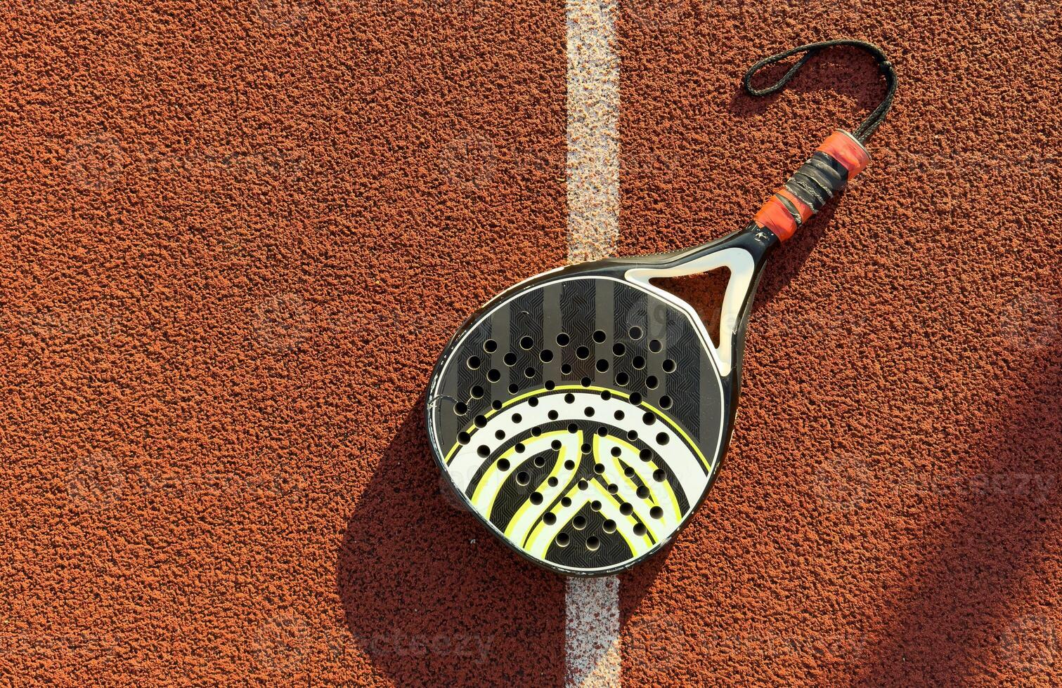 professional paddle tennis racket with natural lighting on court background. Horizontal sport theme poster, greeting cards, headers, website and app photo