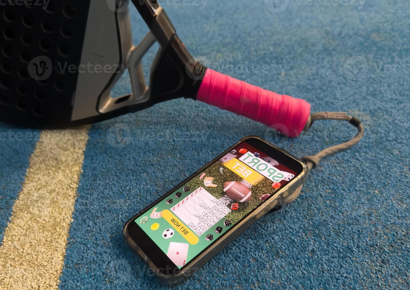 padel tennis racket and smartphone with betting photo