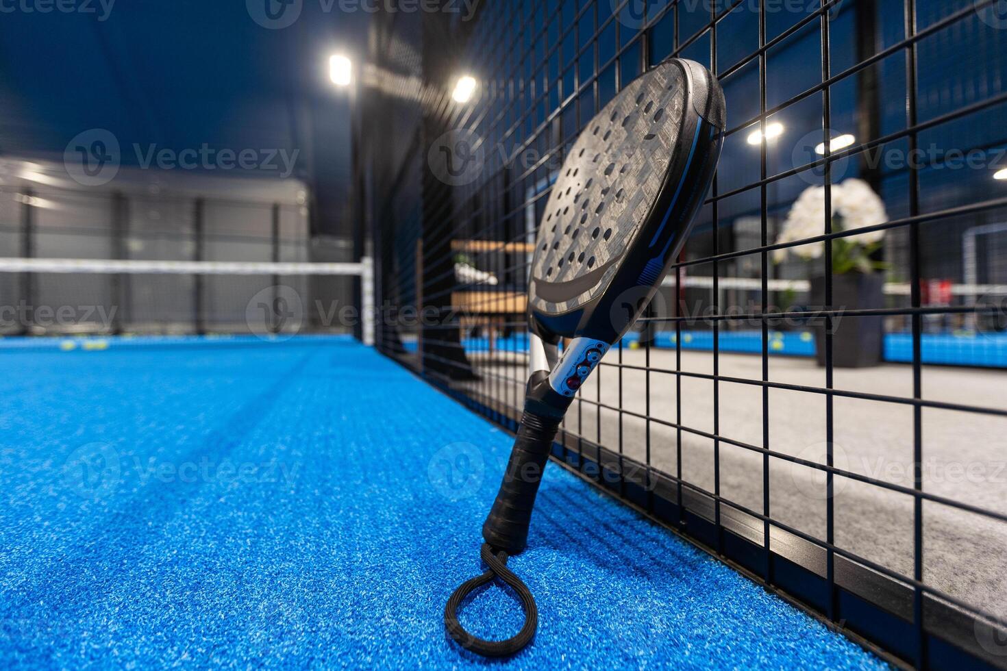 professional paddle tennis racket with natural lighting on blue background. Horizontal sport theme poster, greeting cards, headers, website and app photo