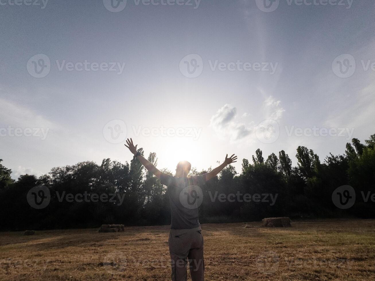 man praying towards the sky photo