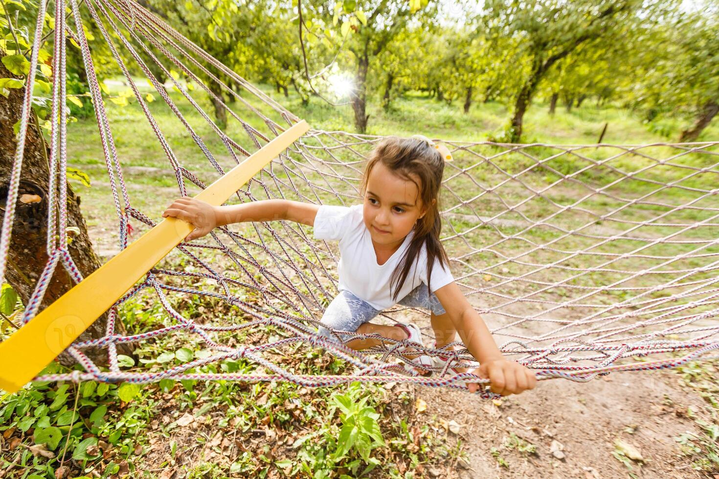 Summer vacation - Hammock Relaxing Child rest. Little girl lying lazily in hammock photo