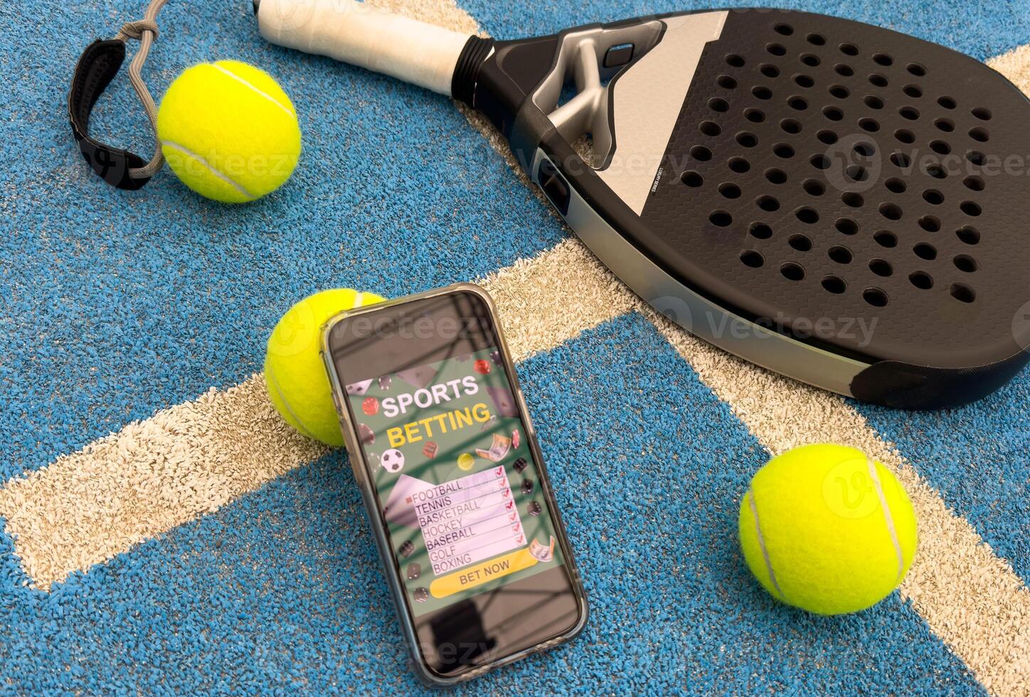 padel tennis racket and smartphone with betting photo
