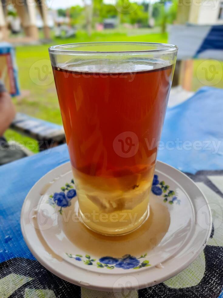 serving hot ginger tea at a drink shop in Indonesia photo
