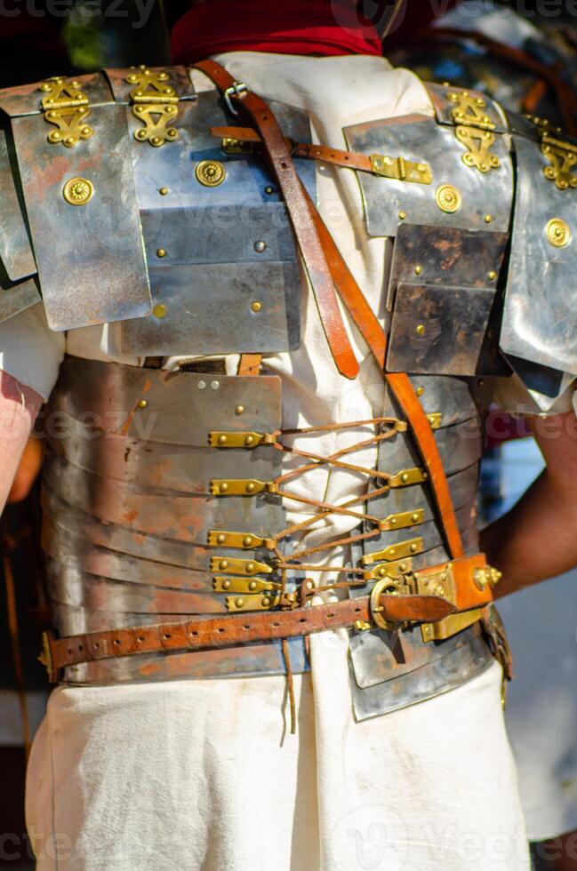 roman soldier with his back turned in lorica segmentata armor at a historical reenactment event photo