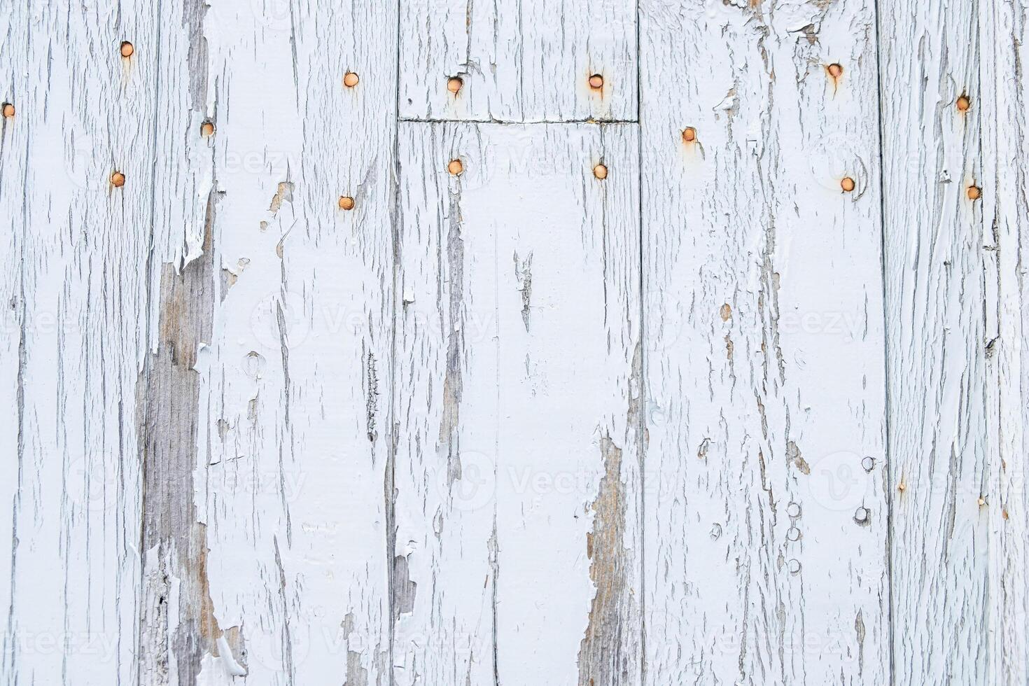 An old weathered wooden wall with a white paint striped pattern creates a rustic background. photo