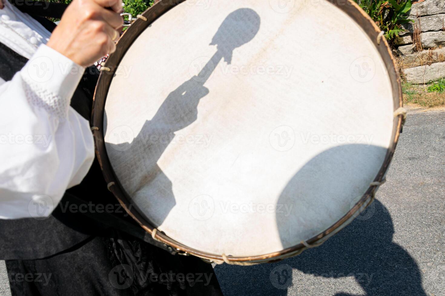 selective focus, hand of a person playing a bass drum. Traditional folk music from Galicia, Spain photo
