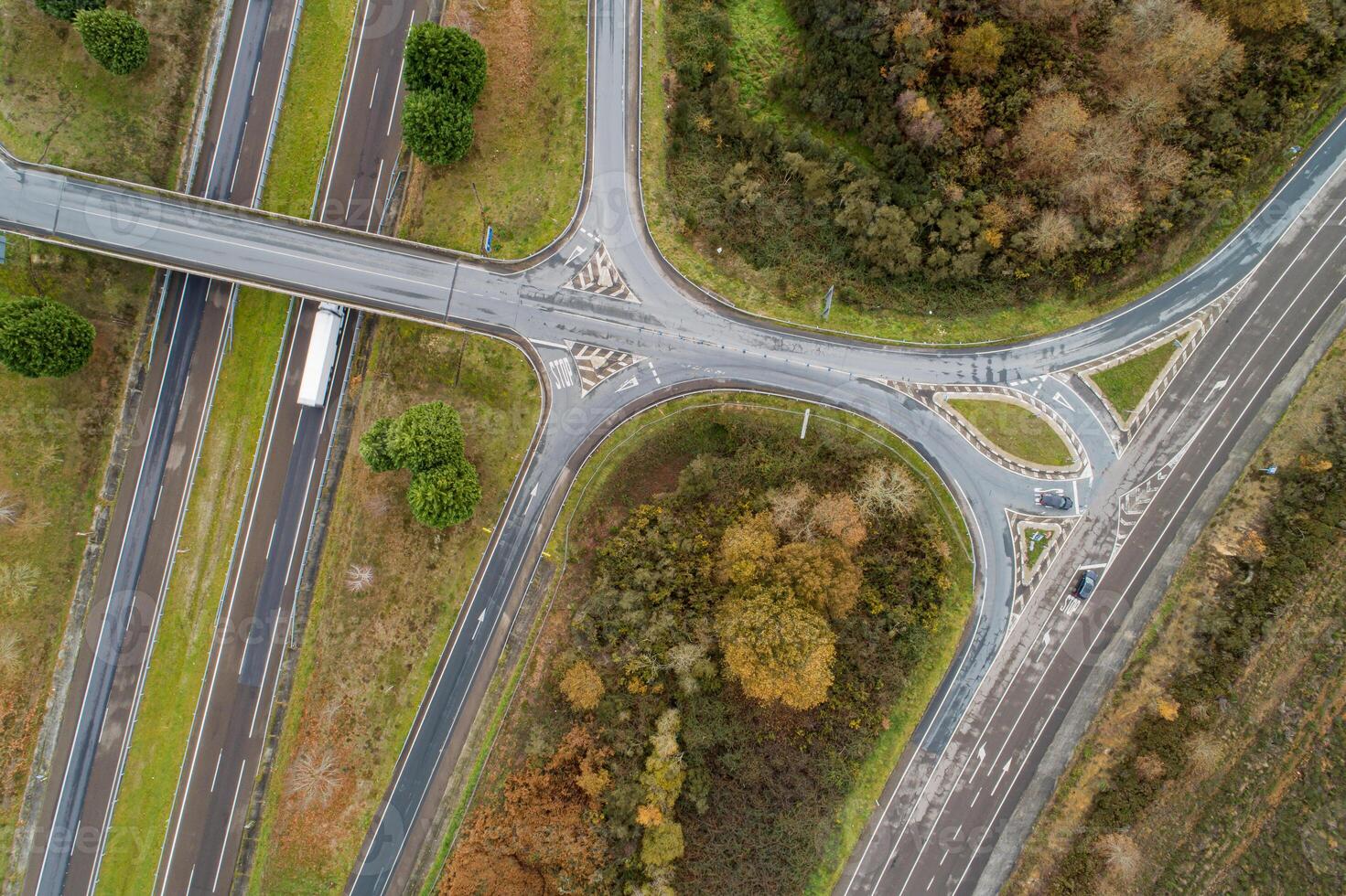 aerial top view of the access to a highway in an autumn landscape photo
