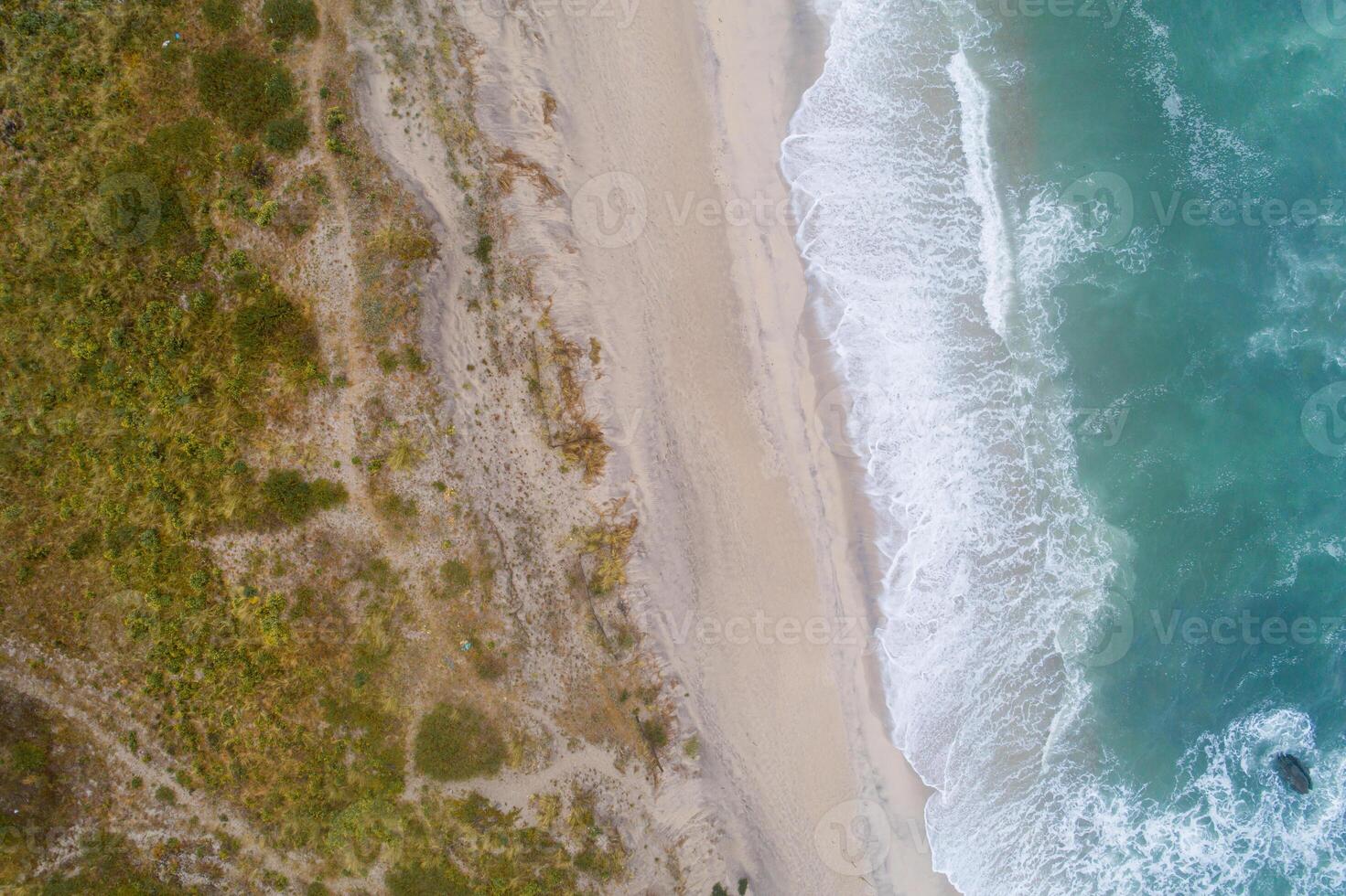 Aerial top view of beautiful tropical white sand beach with wave foam and transparent sea, Summer vacation and Travel background with copy space, Top view from drone photo