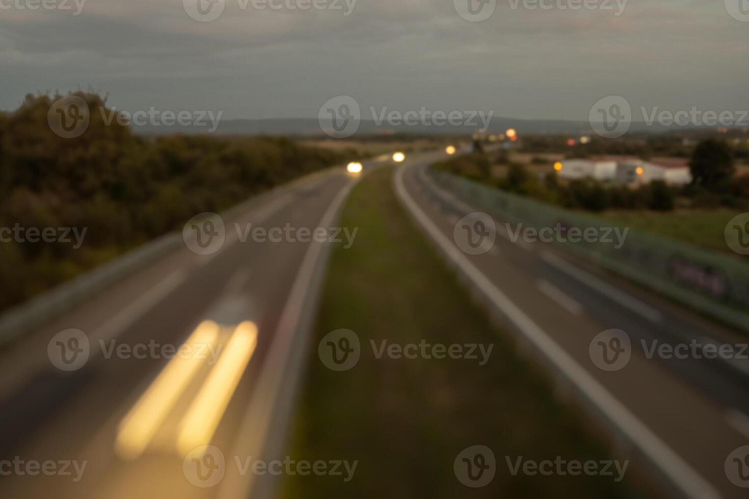 Abstract blurred traffic in a highway at sunset photo