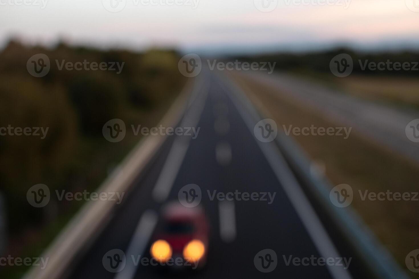 Defocused view of automobile traffic on a highway in Spain at sunset photo