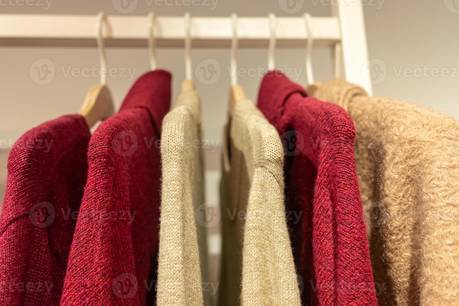 selective focus, fine wool sweaters hung on hangers in a store photo