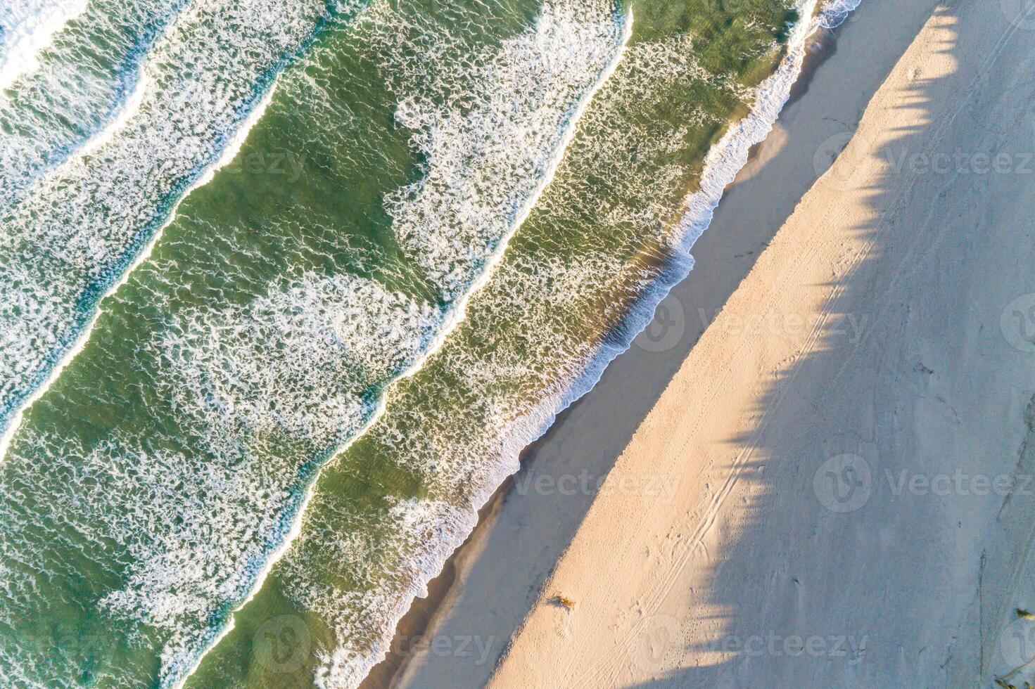 aerial drone photography of a empty beach shore at sunset, overhead view photo