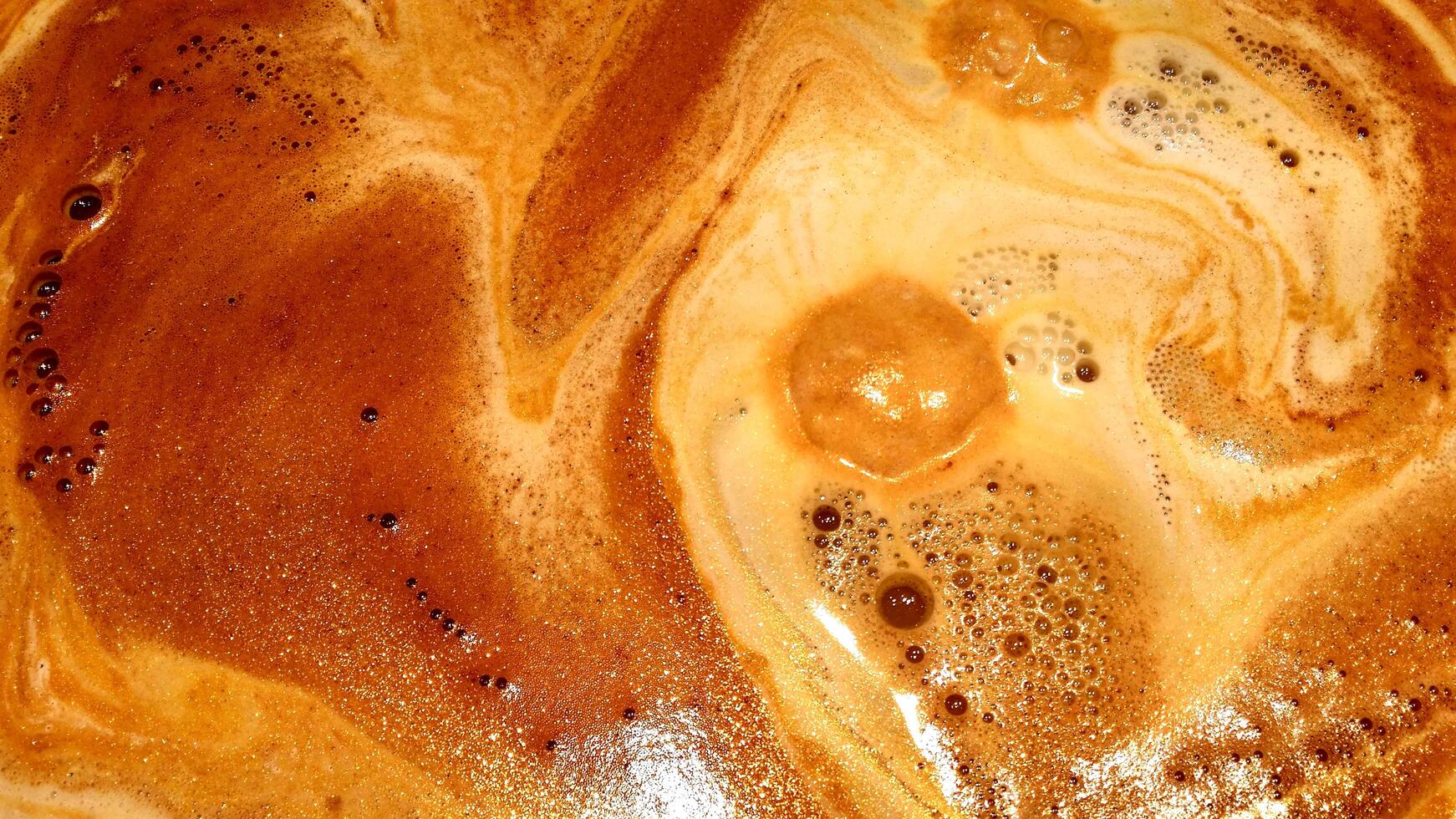 The foam of the espresso just out of the valve of the machine. photo